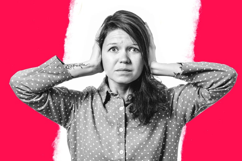 Woman looking exasperated covering her ears.